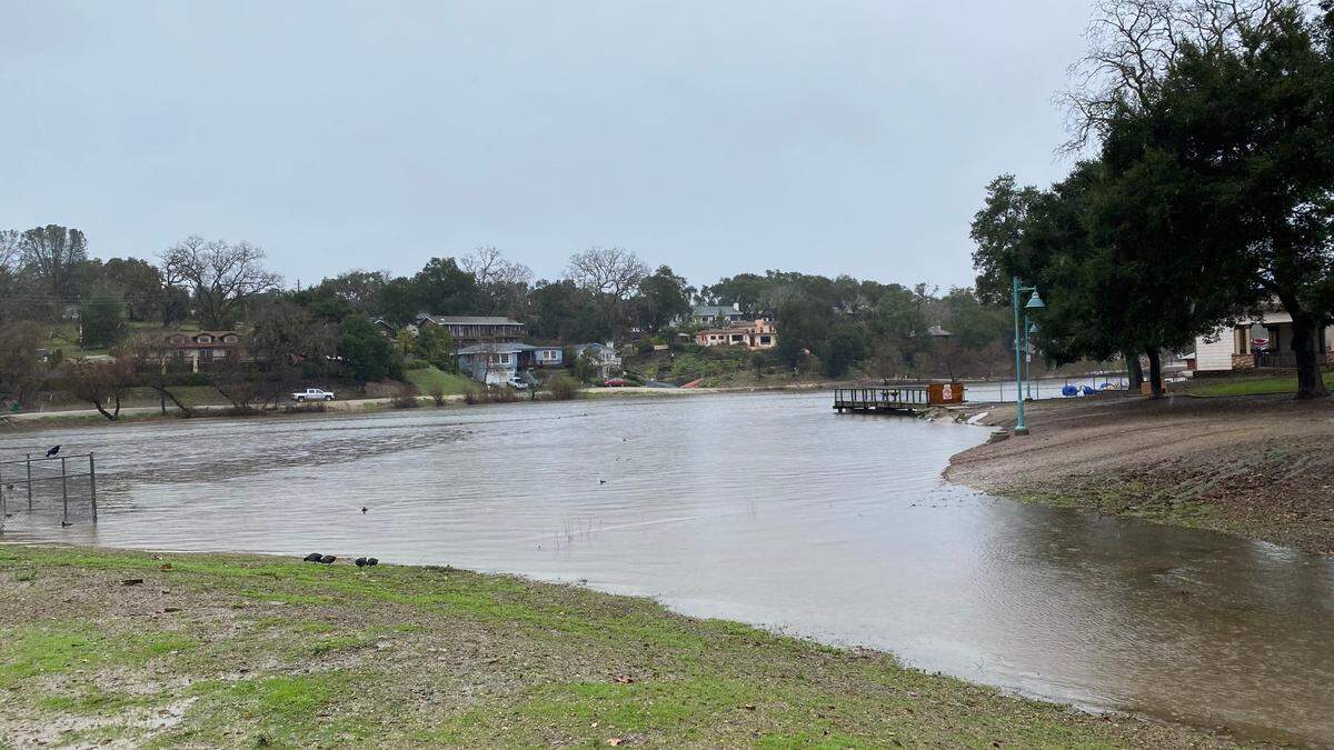 Atascadero Lake overflows into its spillway on Jan. 9, 2023.