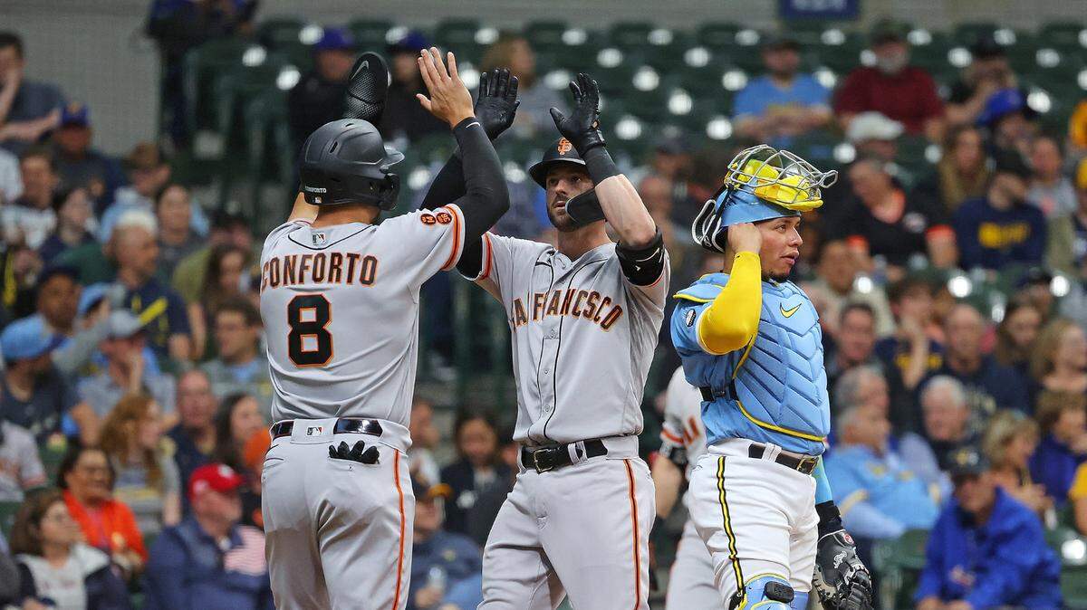 The San Francisco Giants’ Mitch Haniger (17) is congratulated by teammate Michael Conforto (8) after hitting a two-run home run against the Milwaukee Brewers during the second inning at American Family Field on Friday, May 26, 2023, in Milwaukee.