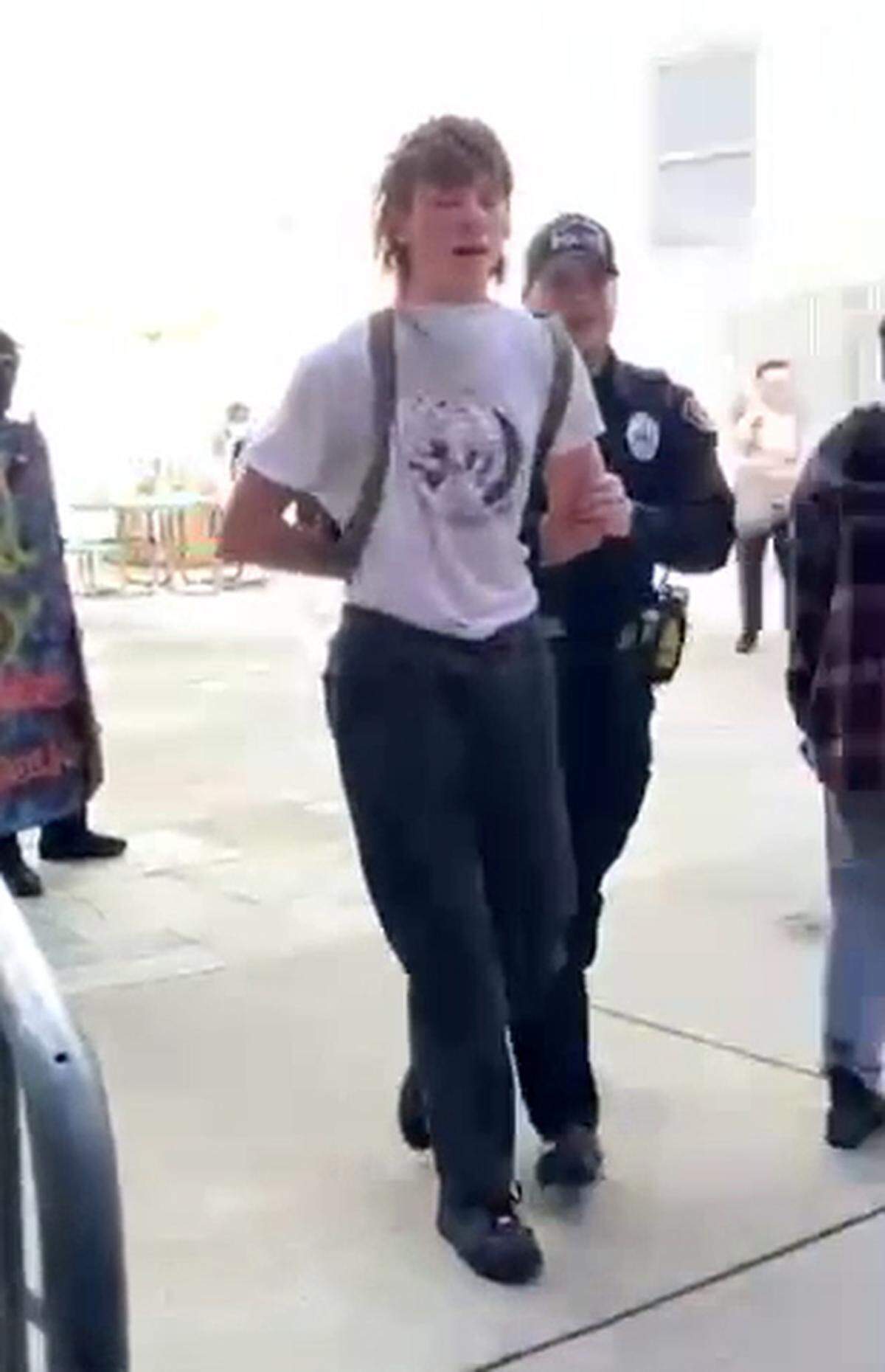A San Luis Obispo police officer arrests a protester during an pro-Palestine demonstration at Cal Poly on Jan. 23, 2024.