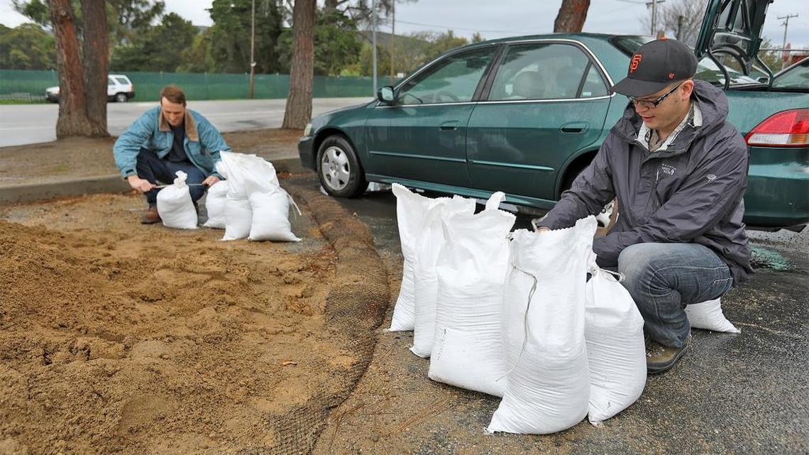 San Luis Obispo resident Scott Nuss and Damon Hyde prep for the rains by building sandbags on Saturday, Jan. 7, 2017. The sand is located at the City Corporate Yard on Prado Lane in San Luis Obispo.