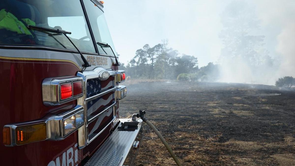 A fire engine sits at the scene of a vegetation fire near Santa Lucia Middle School in Cambria on Sunday afternoon. Firefighters contained the fire at a quarter-acre.