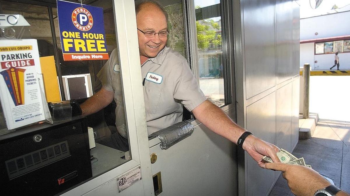 Drivers in San Luis Obispo can now use credit and debit cards instead of just cash to pay for parking in downtown garages. In this file photo, parking attendant Bill Paterson takes in a parking fee at the Palm Street garage.