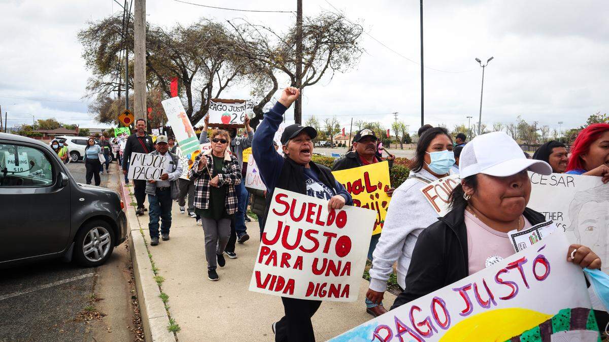 About 80 people protested the Santa Maria Strawberry Festival on April 27, 2025. They called for the Santa Barbara County Board of Supervisors to set a $26 per hour minimum wage for farmworkers.