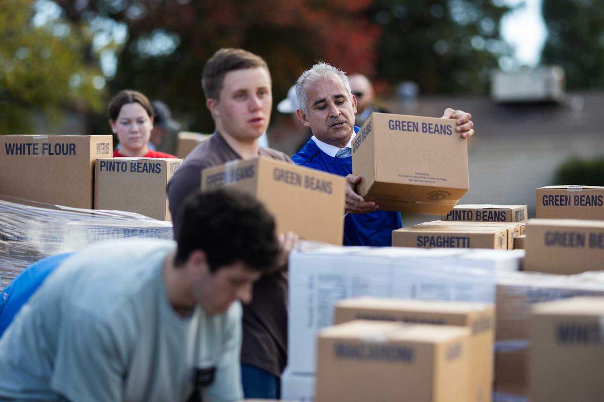 President Juan Rodriguez of the Church of Jesus Christ of Latter-day Saints loads boxes of green beans onto a pallet on Thursday, Nov. 16, 2023, in Paso Robles.