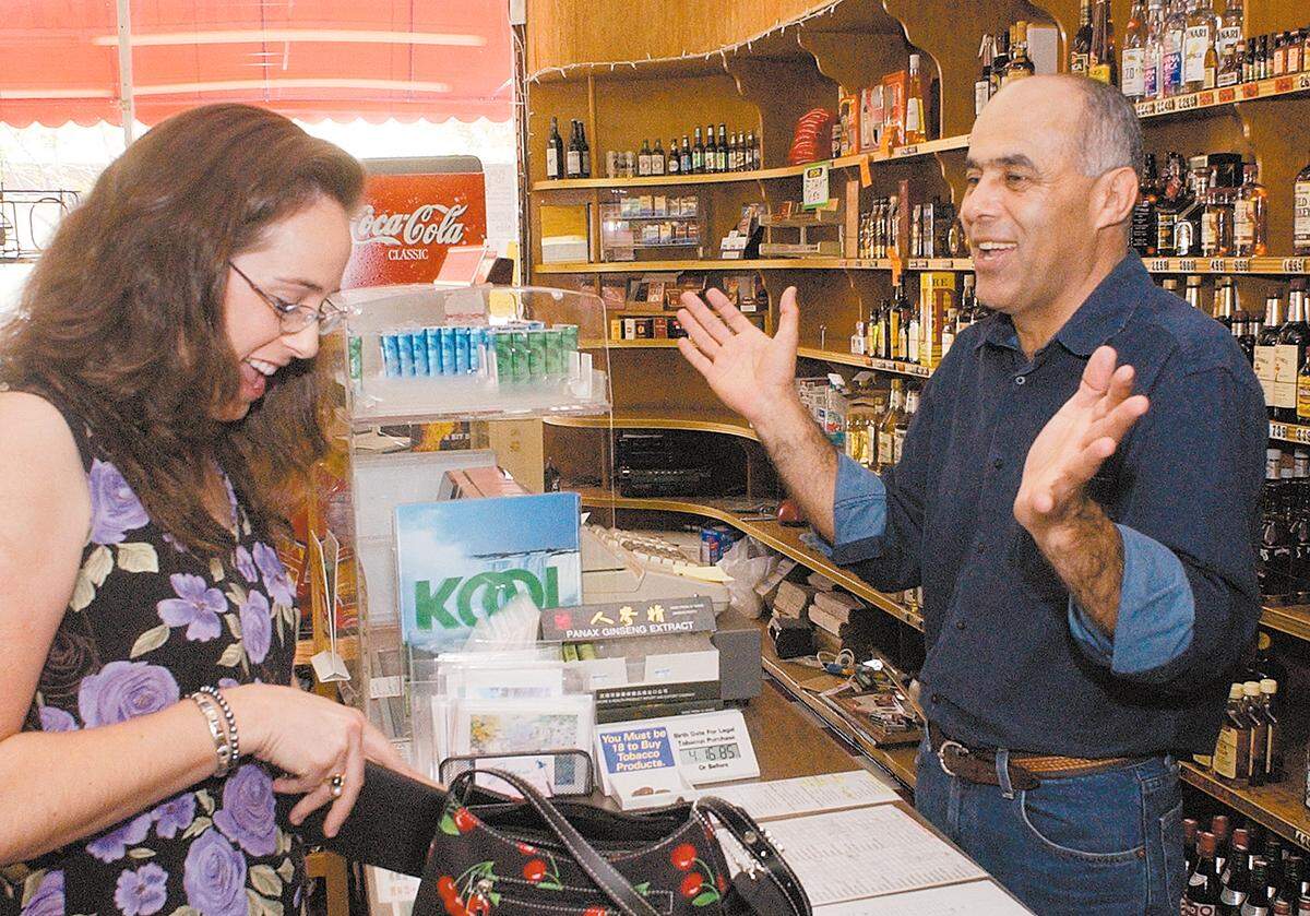 Adnan Saleh jokes with customers Faith Case at Jaffa Cafe, originally known as Cornerstone Market and Deli, in San Luis Obispo in 2003.