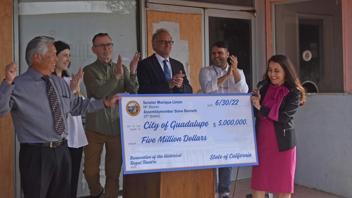Guadalupe Mayor Ariston Julian, Asia King of the U.S. Economic Development Administration, Tom Brandeberry of Los Amigos de Guadalupe, City Administrator Todd Bodem, Chachi Ramirez and Sen. Monique Limon gather near the oversized check for a $5 million state grant for the Royal Theater renovation.