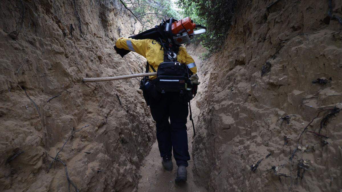 Firefighter hikes up steep Broderson Trail on the way to fire at Montaña de Oro State Park on Friday, Aug. 4, 2023.