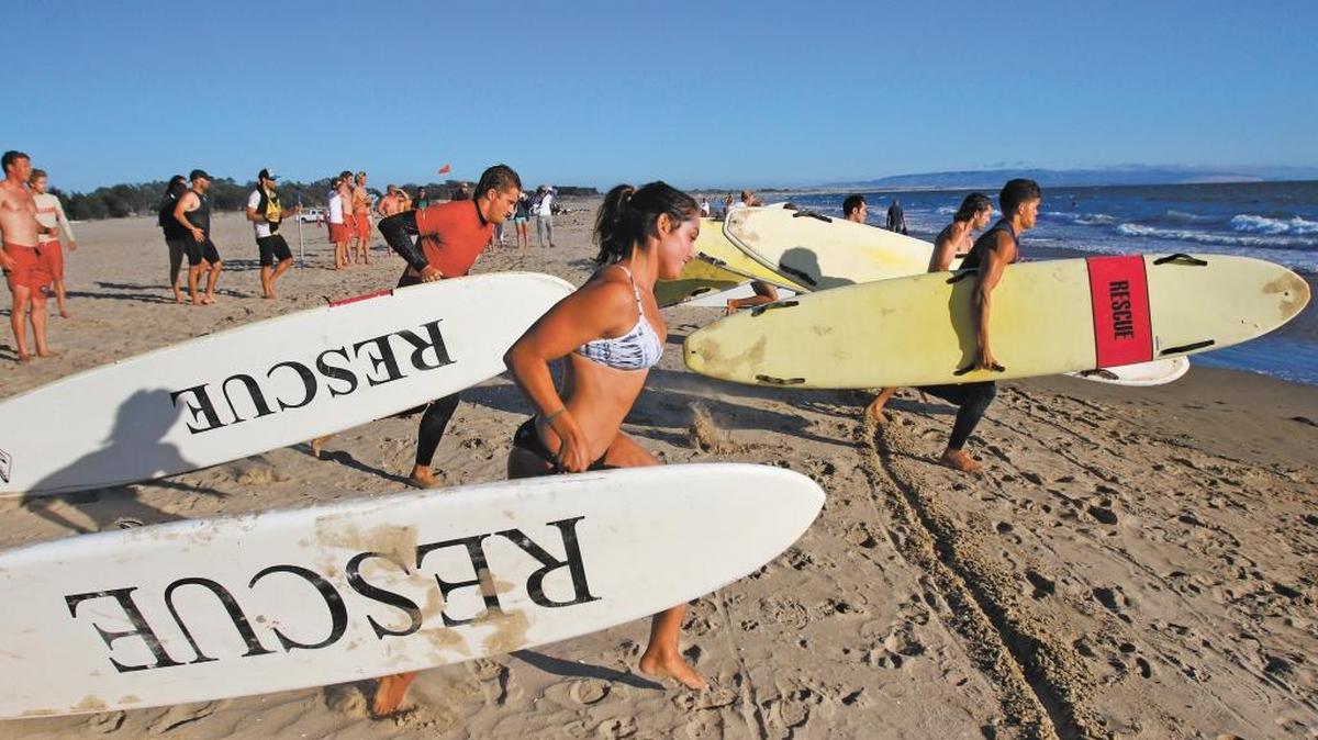 Donna Donath, Calvin Gonder (in red) and Jamie Flanagan (at right) were among those participating in the annual Central Coast Lifeguard competition held in Pismo Beach in August.