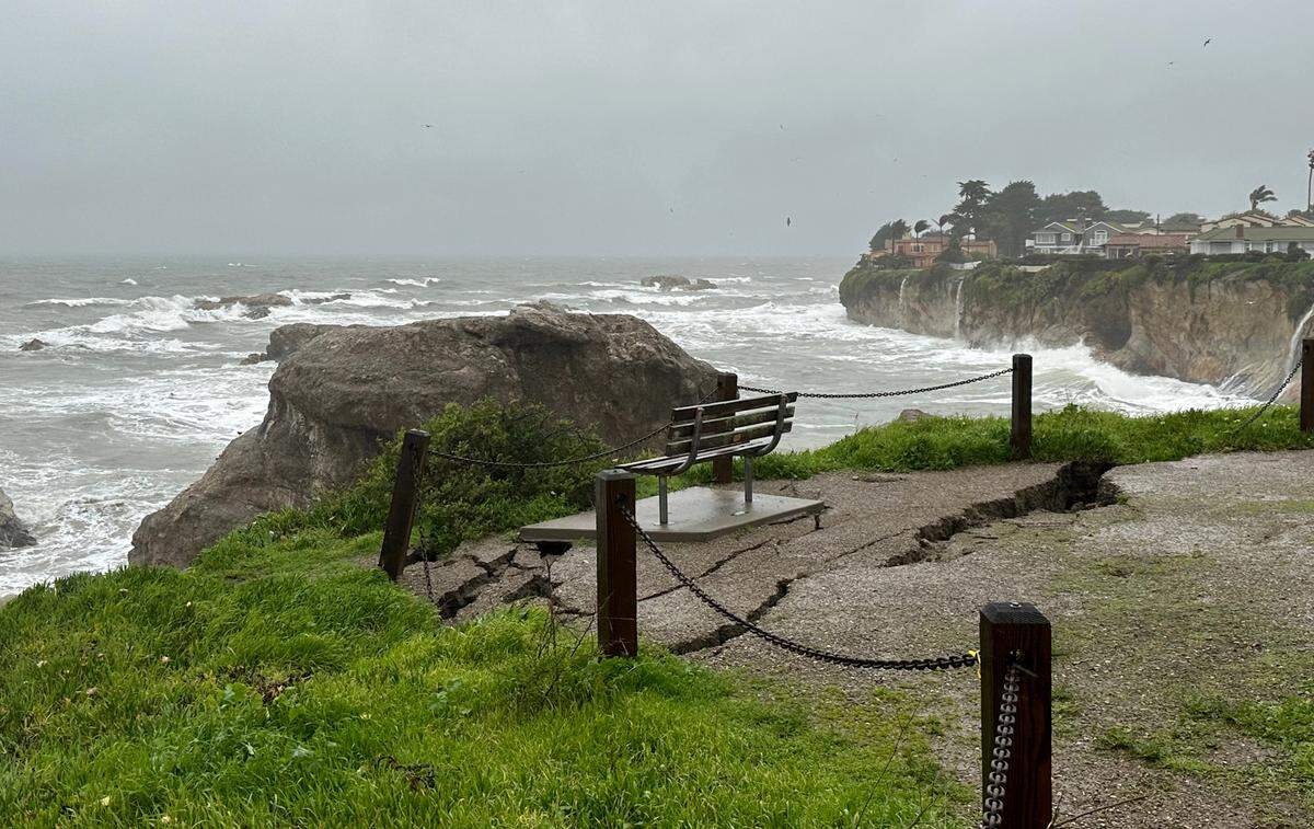 A cliffside bench is at risk of tumbling to the beach below as a crack grows behind it at Margo Dodd Park in Shell Beach. The bench is dedicated to Ralph Clement. The crack expanded dramatically overnight due to the storms Jan. 9, 2023.