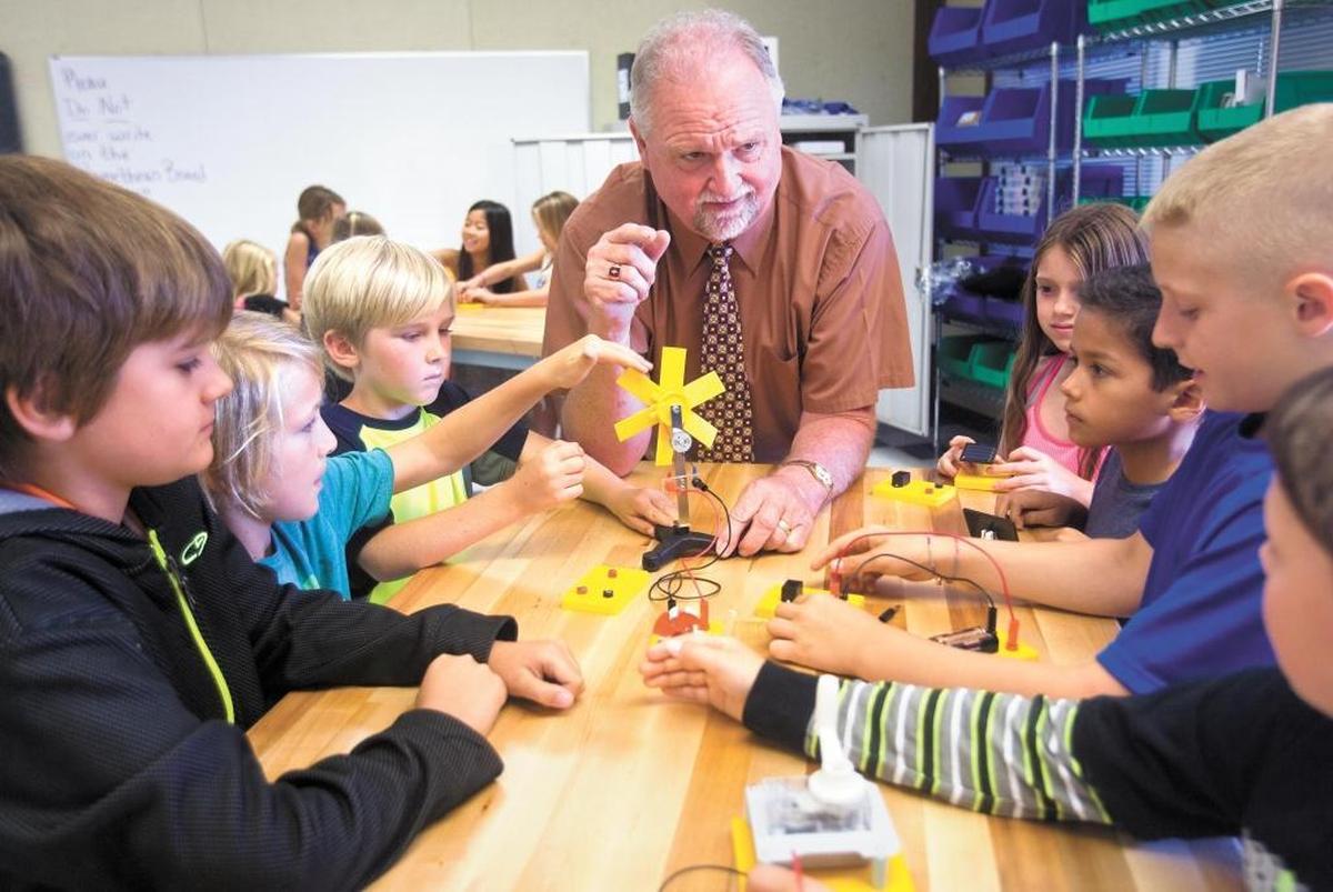 Guy Crabb, a fourth-grade teacher at Teach Elementary School, talks to students about a science project in August 2014. A new nonprofit has been formed to support the San Luis Coastal district.
