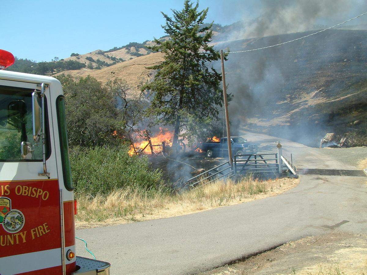 This July 2003 fire burned to the ground the Cold-War-era home of San Simeon Creek Road rancher Bill Warren. He was the ‘acquired brother’ of Tribune columnist/reporter-photographer Kathe Tanner, who was assigned to cover the fire.