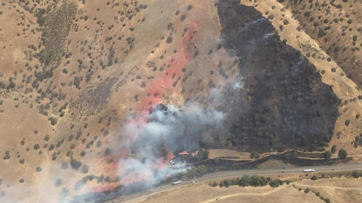 Cal Fire and Kern County fire crews battle a grass fire near the Kern-San Luis Obispo county line.