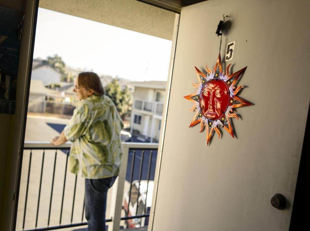 Marc Robb stands on the landing outside his apartment in Pismo Beach. He pays the rent with help from the Veterans Affairs Supportive Housing program.