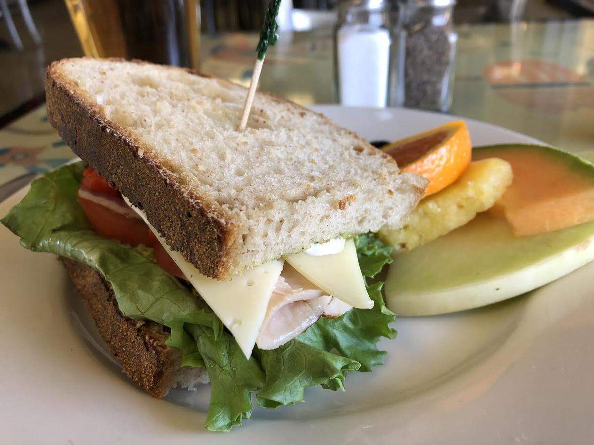 The turkey grinder from Hush-Harbor Artisan Bakery and Café in Atascadero comes with turkey breast, swiss cheese, lettuce, tomato, roasted red pepper, red onion, pesto, Caesar sauce and balsamic vinaigrette on your choice of bread. This sandwich came with a side of fresh fruit.