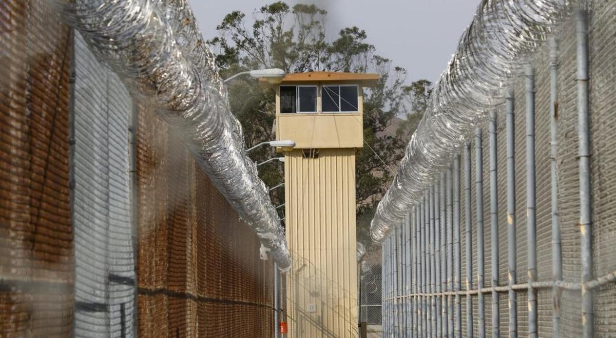 A tower overlooks cyclone fences topped with razor wire at the California Men’s Colony outside San Luis Obispo.