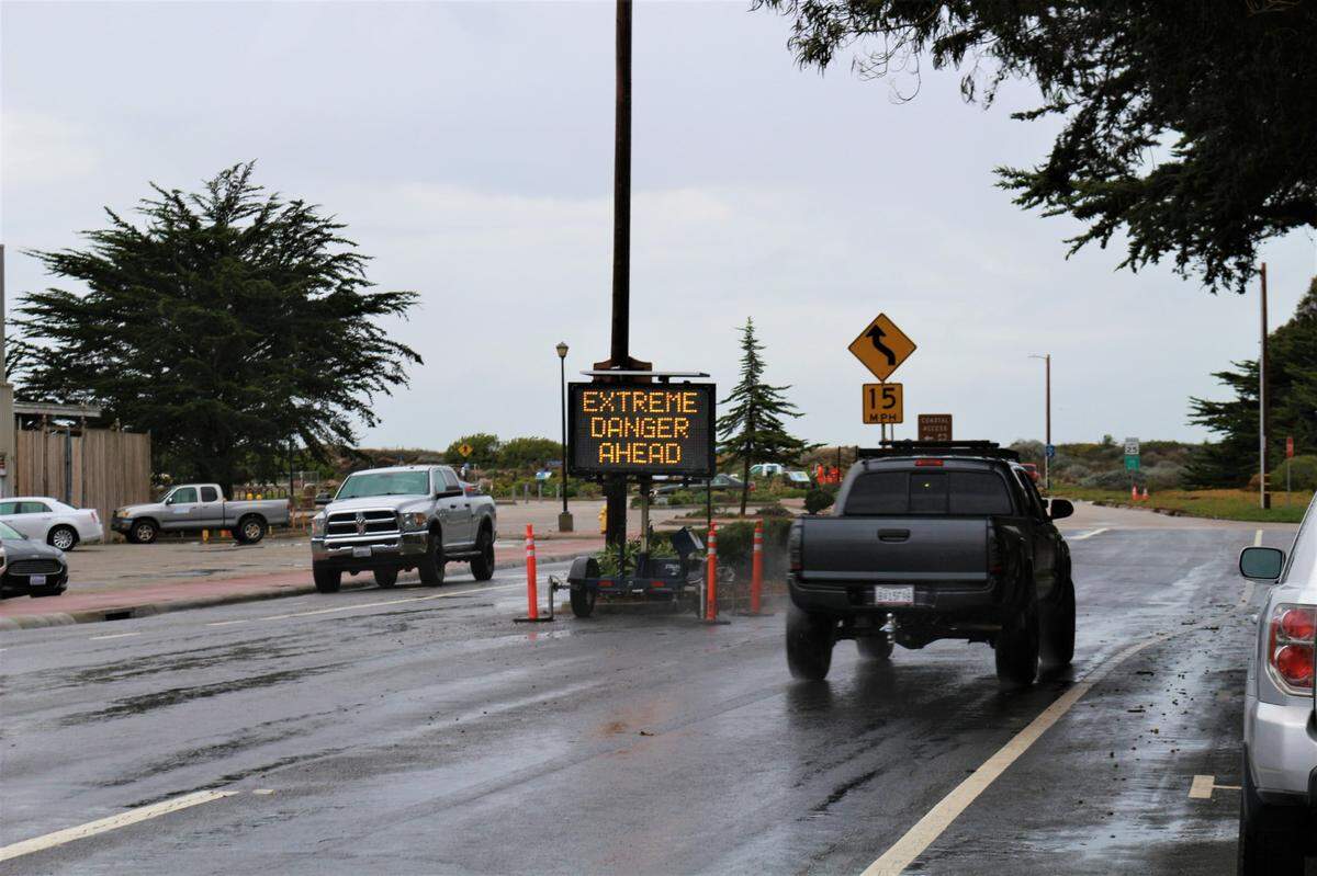 A sign warns of “extreme danger ahead” at the entrance to Morro Rock Beach on Jan. 4, 2023. Up-to-30-foot swells were expected along the coast due to a winter storm.