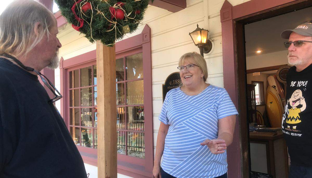 Cambria Surf Shop owner Bill Bookout, at left, chats with customers Patti and Steve Weber of Pleasant Hill on Oct. 11, 2022.