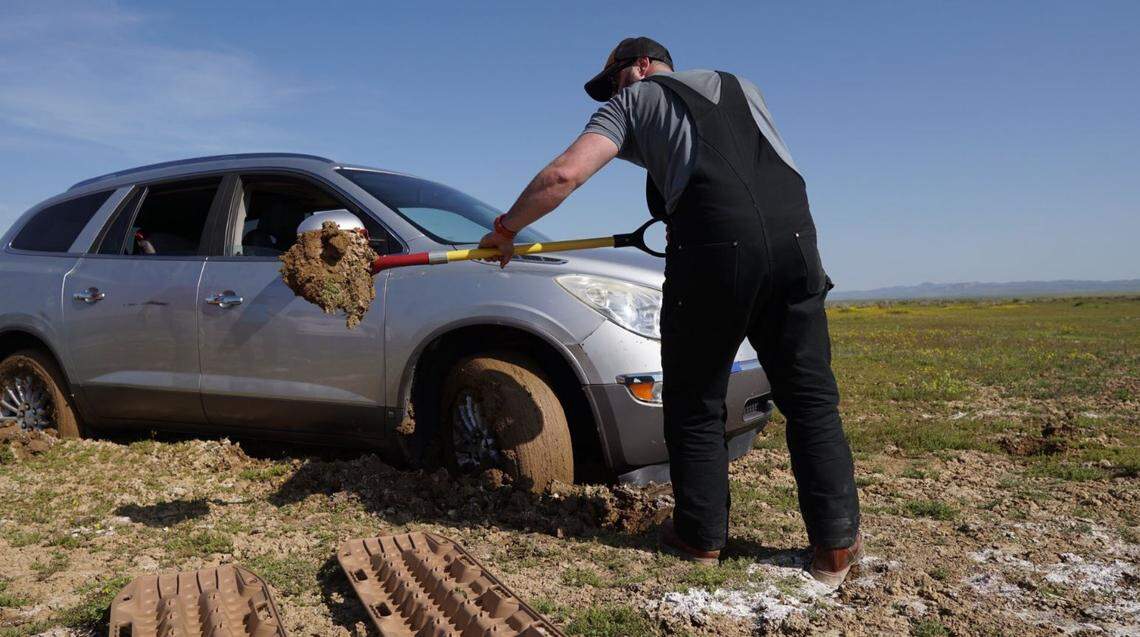 Matthew Wilkins helps retrieve a vehicle stuck in clay mud near the Carrizo Plain National Monument.
