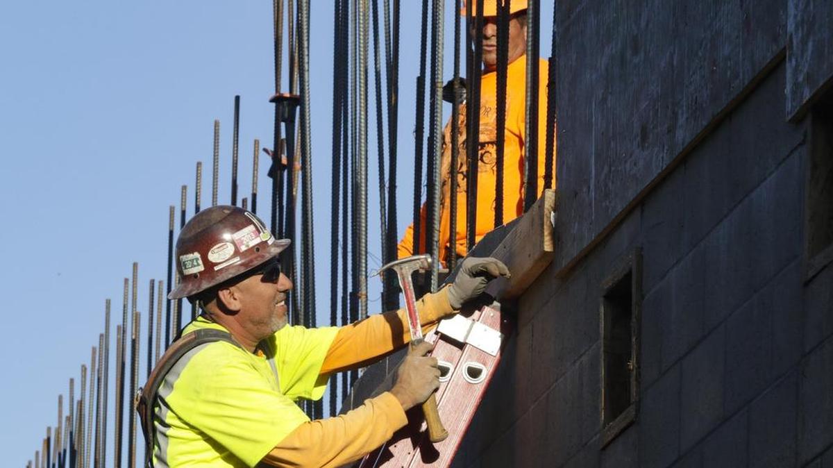 Carlos Romero hammers a board into place while working at the Garden Street Terraces development in downtown San Luis Obispo.