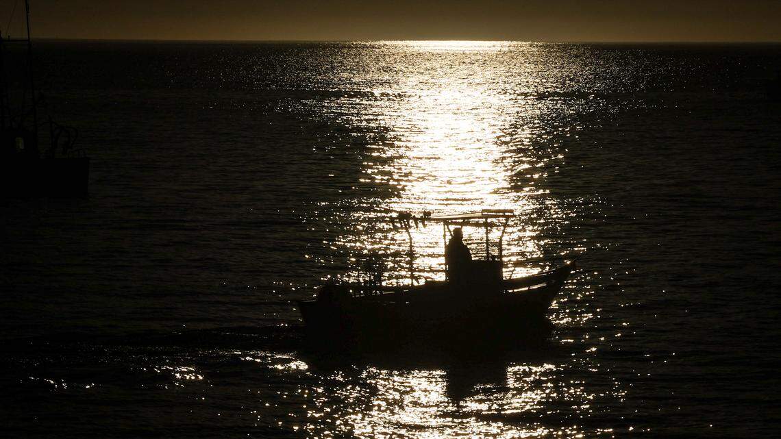 A boat heads out from Port San Luis as the sun rises near Avila Beach on Monday, Jan. 29, 2024.