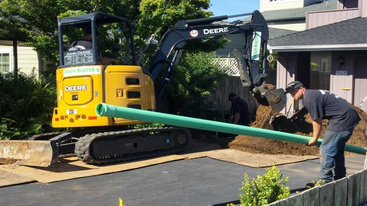 A worker installs a lateral connection from a Los Osos home to the main sewer line last month.