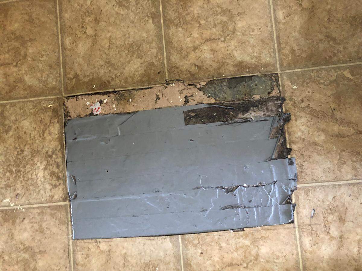 A ripped linoleum floor patched with duct tape in one resident’s unit at the Grand View Apartments complex in Paso Robles.