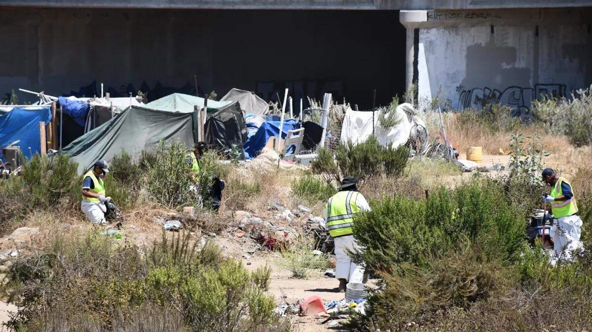 Workers remove homeless encampments in the Santa Maria Riverbed on Thursday, July 26, 2024, as part of a coordinated cleanup effort led by Santa Barbara County, although the area falls under the jurisdiction of San Luis Obispo County.  