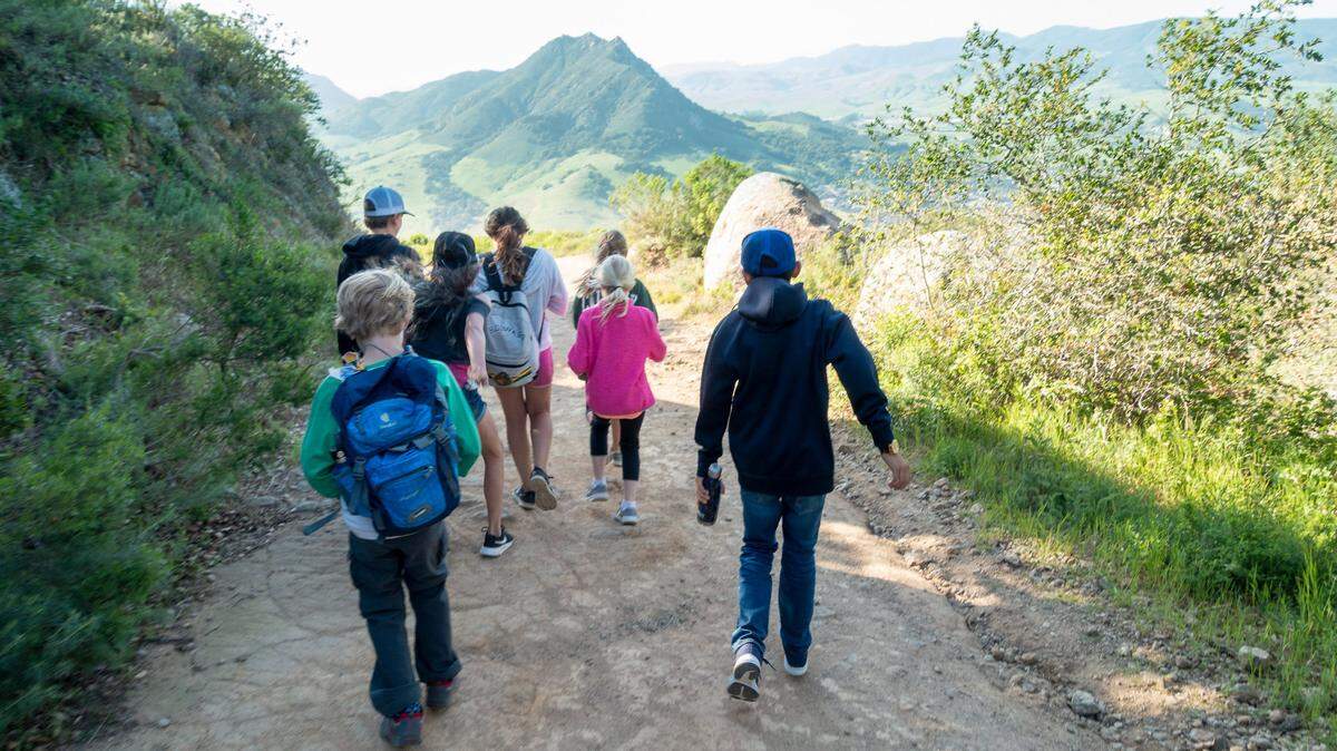 Hikers walk up Cerro San Luis.