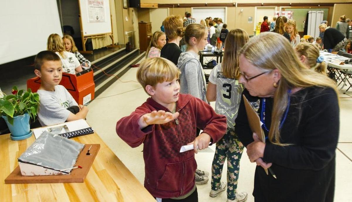Jace Hudgers, 10, talks to judge and San Luis Coastal School Board trustee Marilyn Rodger about a desalination project his 4th grade class worked on.
