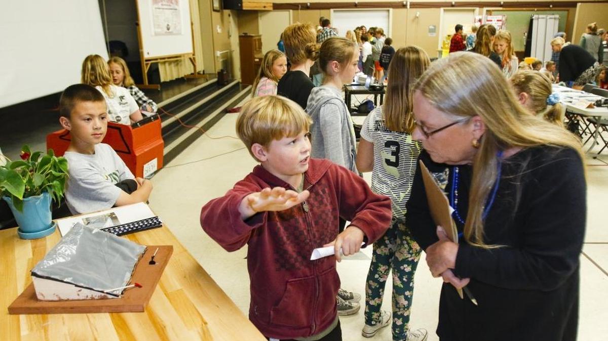 Jace Hudgers, 10, talks to judge and San Luis Coastal School Board trustee Marilyn Rodger about a desalination project his 4th grade class worked on. Fourth annual Innovation and Exploration showcase at Teach Elementary. Each class has been working STEAM projects — science, technology, engineering, arts, and math components.