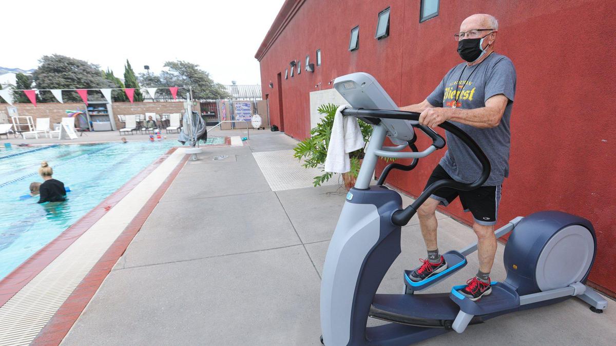 Richard Dodder works on an elliptical machine. Kennedy Club managing partner, Brett Weaver, operating outdoors has required costly repairs to machines.