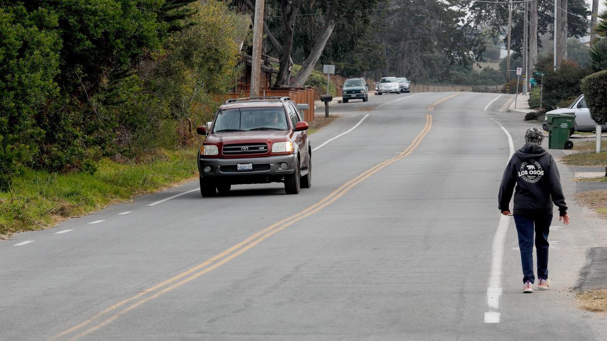A car drives down Ramona Avenue in Los Osos, where Dale Paulsen, pastor of Morro Bay Presbyterian Church, was killed in a hit-and-run collision Nov. 18.