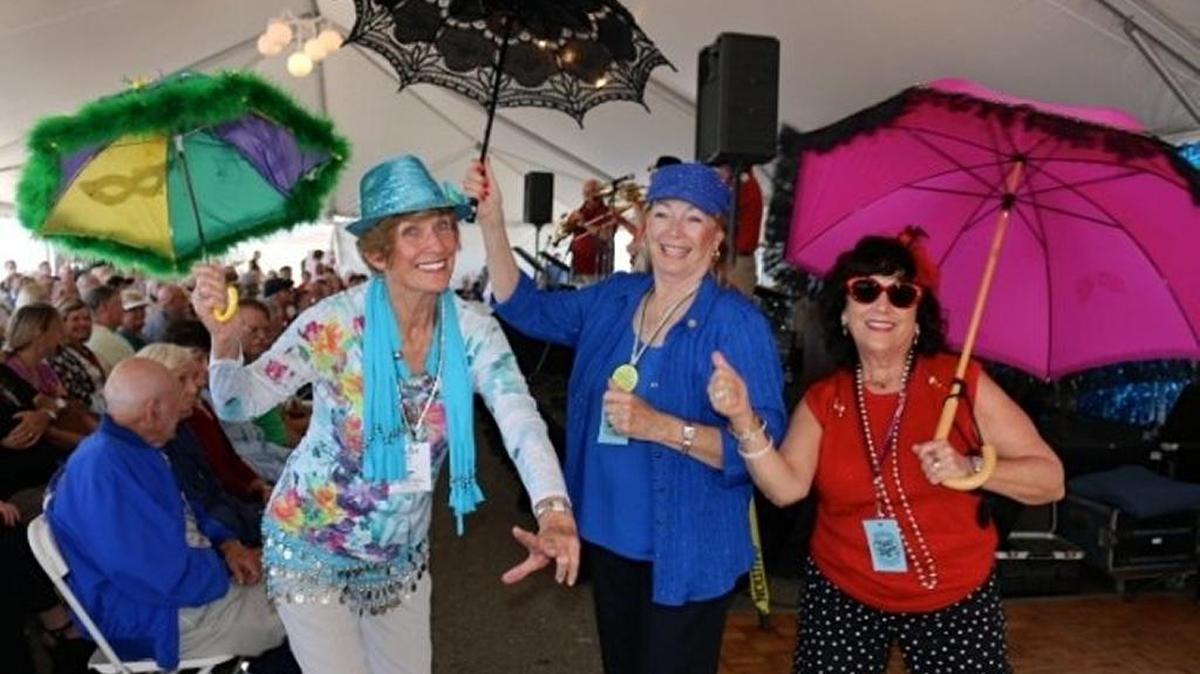 Festivalgoers participate in a New Orleans-style parasol parade at Jubilee by the Sea. The jazz festival, which features concerts in Arroyo Grande and Pismo Beach, concludes Sunday.