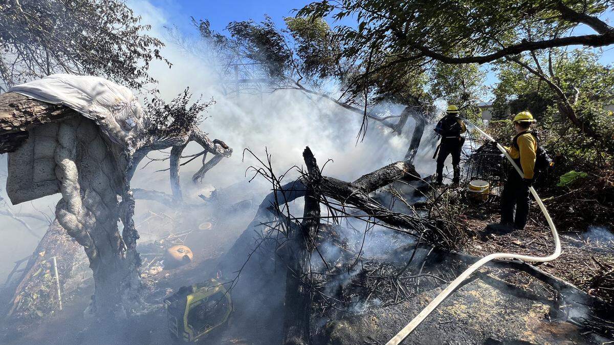 A vegetation fire destroyed a billboard along Highway 101 in SLO on June 18, 2022.