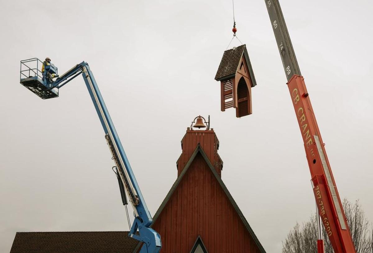 Workers remove the steeple at St. Stephen’s Episcopal Church on Monday morning in San Luis Obispo. A fire in the 1970s destroyed the original steeple, and the current one needed replacing.