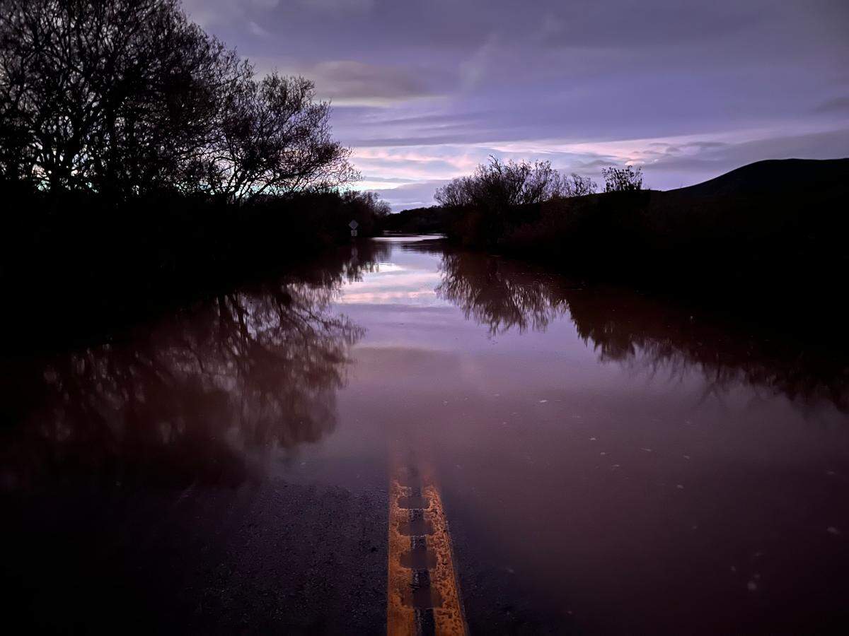 Still floodwaters cover Turri Road near Los Osos in the calm between the storms on Monday evening, Jan. 9, 2023.