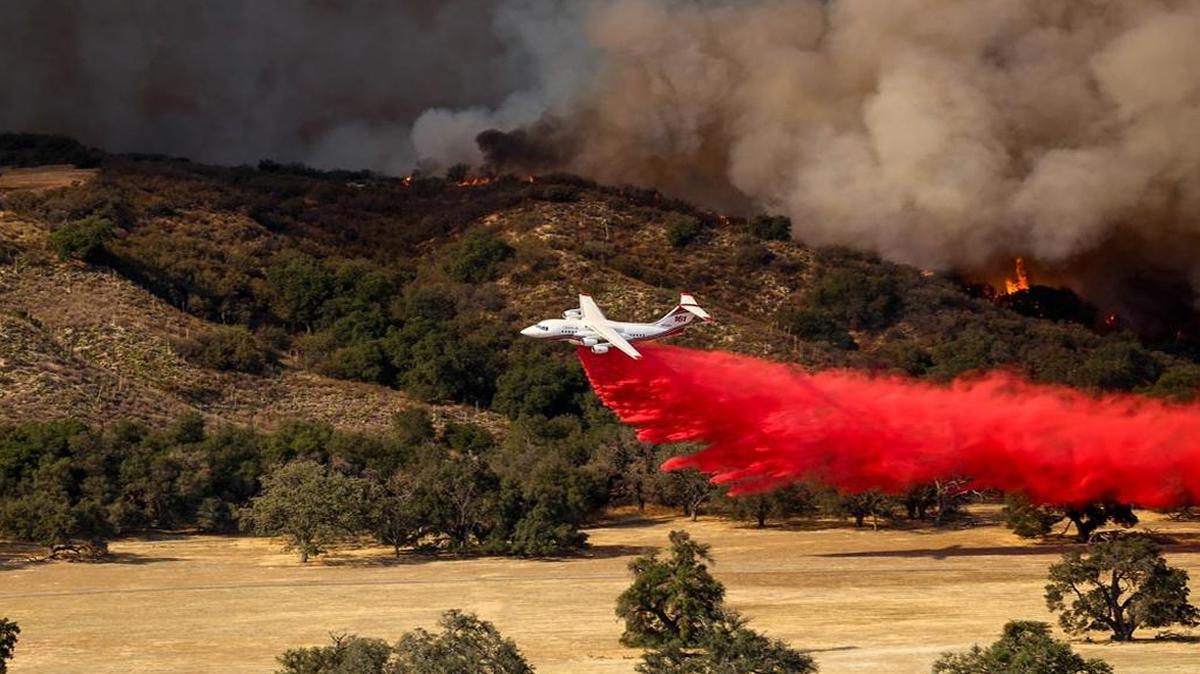 A tanker makes a drop on the Rey Fire Saturday afternoon.