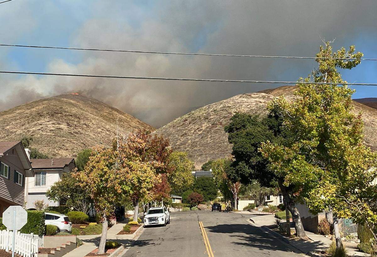 A vegetation fire burns in the hills near Lizzie street in San Luis Obispo on Oct. 30, 2023. The fire apparently started behind the FFA farm at San Luis Obispo High School. Residents nearby were ordered to evacuate.