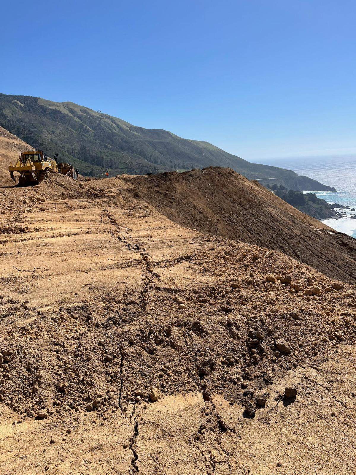 Cracks in the soil high above Highway 1 near Lucia show that land is continuing to move where repair work is happening at the Regent’s Slide area, on March 9, 2025. It’s been closed through traffic since February 2024.