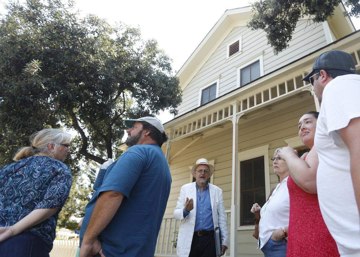 James Papp leads participants on a walking tour of San Luis Obispo’s railroad district organized by Secret SLO. The building in the background is the oldest wood frame commercial building in San Luis Obispo, built in 1873 built for the Tribune and later moved to Santa Barbara Ave.
