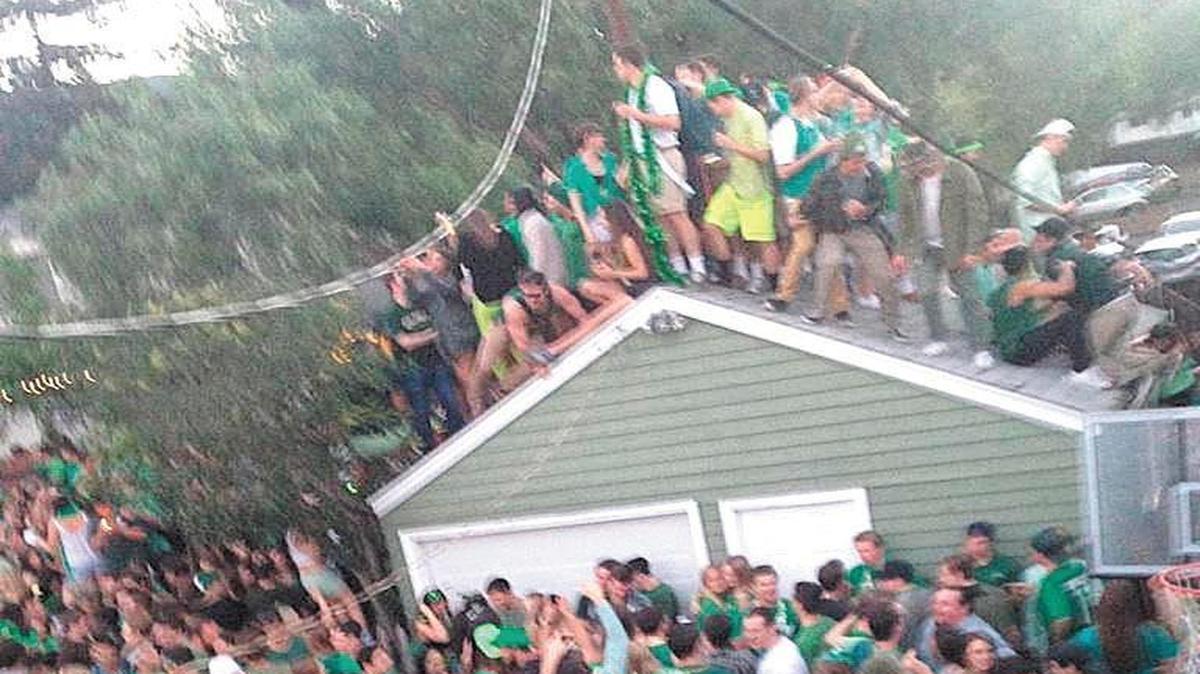 Partiers gather on a garage roof shortly before it collapsed during March 2015 St. Fratty’s Day celebrations at 348 Hathway in San Luis Obispo.