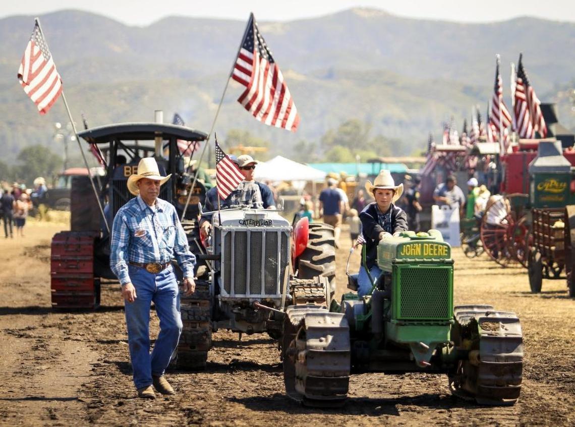 Jake Merrill, 10, of Saratoga, drives his great-great-great grandfather’s John Deere 1940 Model D tractor as his grandfather, Lupe Rodriquez walks beside him in the tractor parade during the Best of the West Antique Equipment Show in 2017.