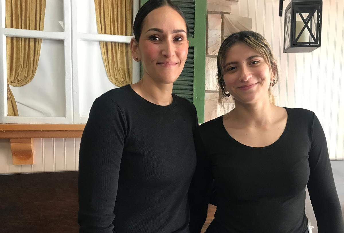 Becky Bonilla, left, San Simeon native and one of four new co-owners of the recently reopened Cambria Cafe, takes a quick time-out Jan. 31, 2025, with daughter Alexa Bonilla, another of the eatery’s servers.