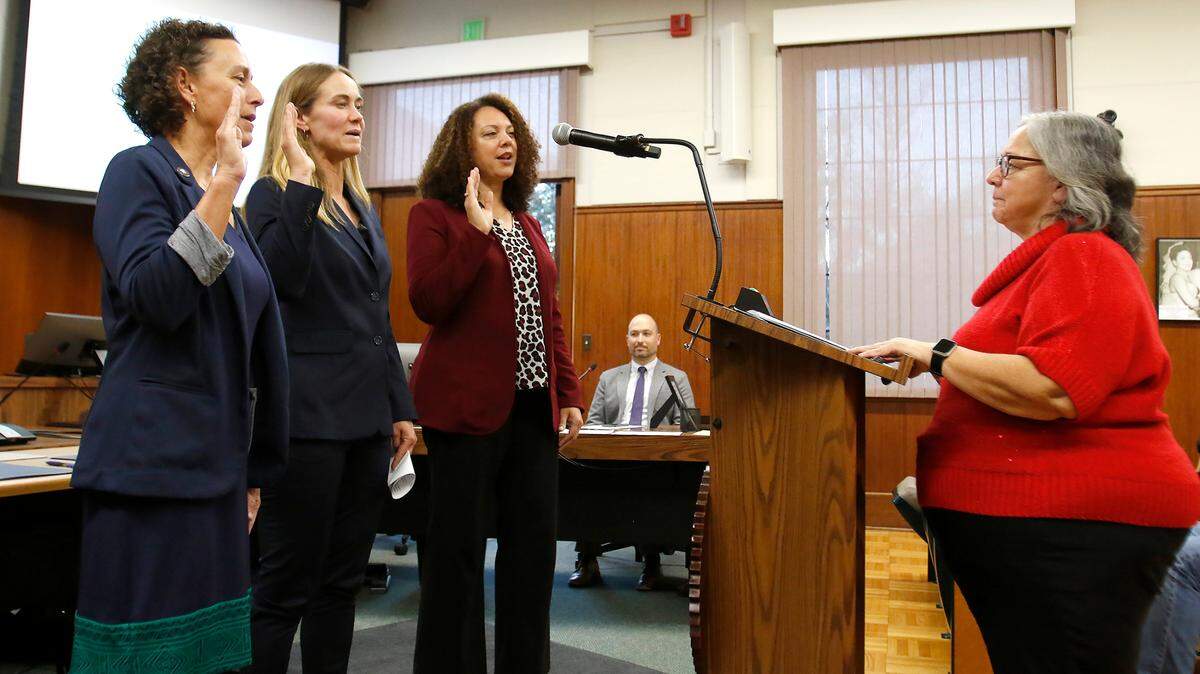 From left, Michelle Shoresman, Emily Francis and Erica Stewart take the oath of office on Friday, Dec. 9, 2022, administered by San Luis Obispo City Clerk Teresa Purrington.