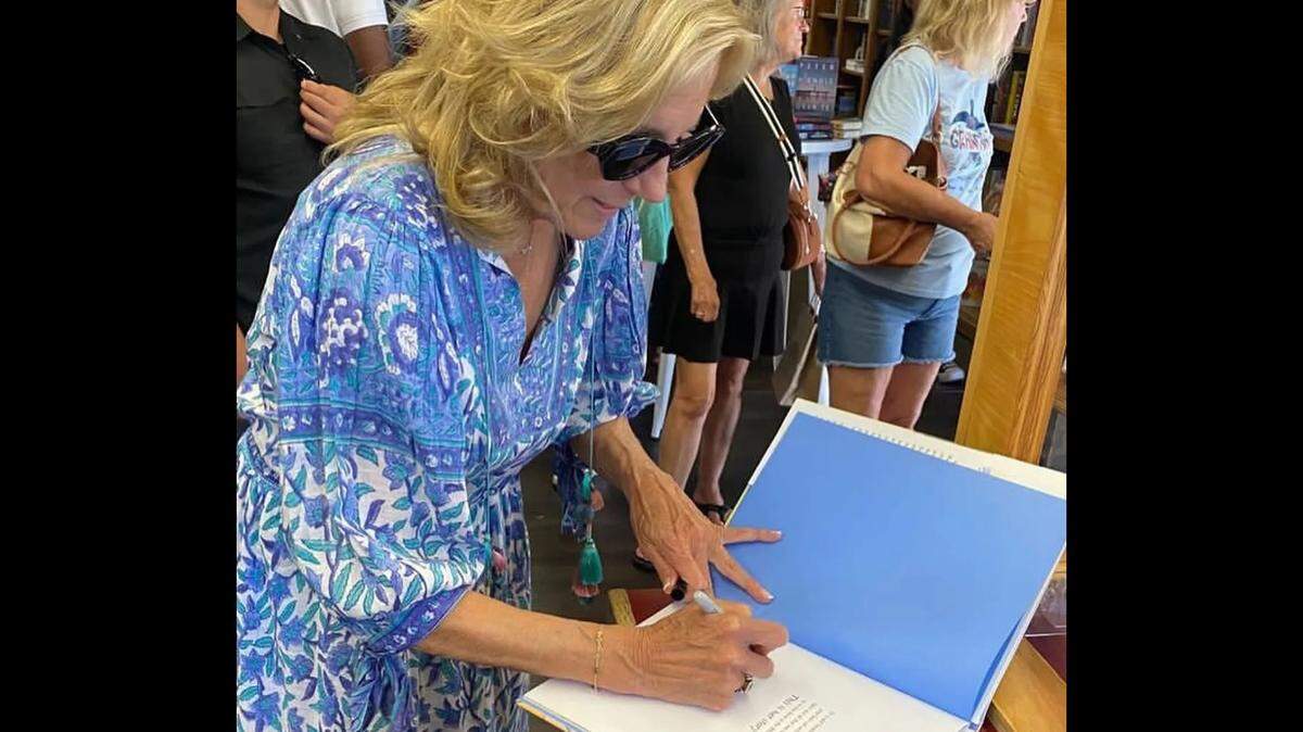 First Lady Jill Biden autographs the children’s book “Willow the White House Cat,” which she wrote, during a visit Thursday, Aug. 22, 2024, to The Book Loft in downtown Solvang.