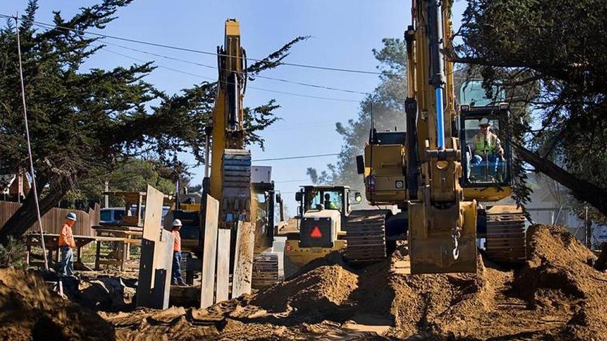 A work crew installs a main sewer line on Pismo Avenue near Seventh Street in Los Osos during the installation of sewer lines in 2014.