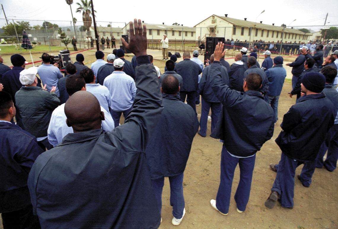 Inmates listen to singer Peter Penrose perfrom on Oct. 29, 2001, at the California Men’s Colony West Facility. The facility for lower-security inmates is slated for closure.