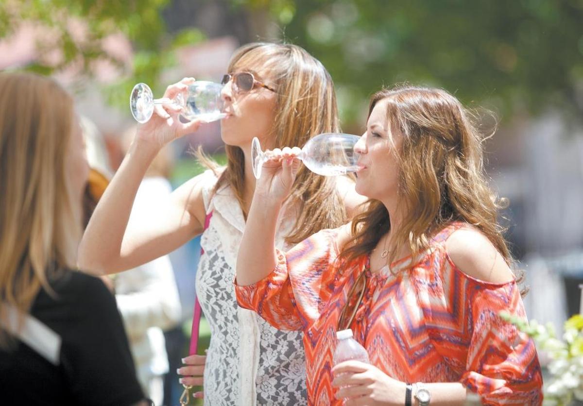Stacie Smith, left, and Jennifer Hinckley, right, of Los Angeles, emptied their glasses while tasting at the Paso Robles Wine Festival in 2015.