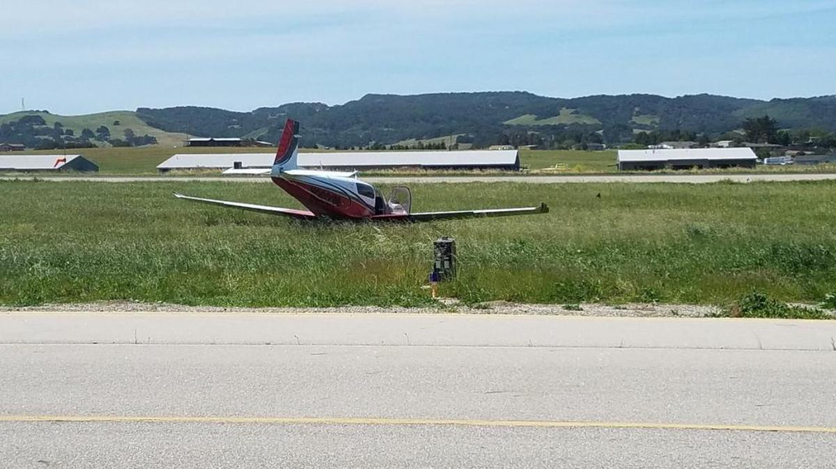A private single-engine aircraft began moving while a pilot was working on it and rolled into a grassy area between runways on Friday. The man was taken to the hospital with minor injuries.