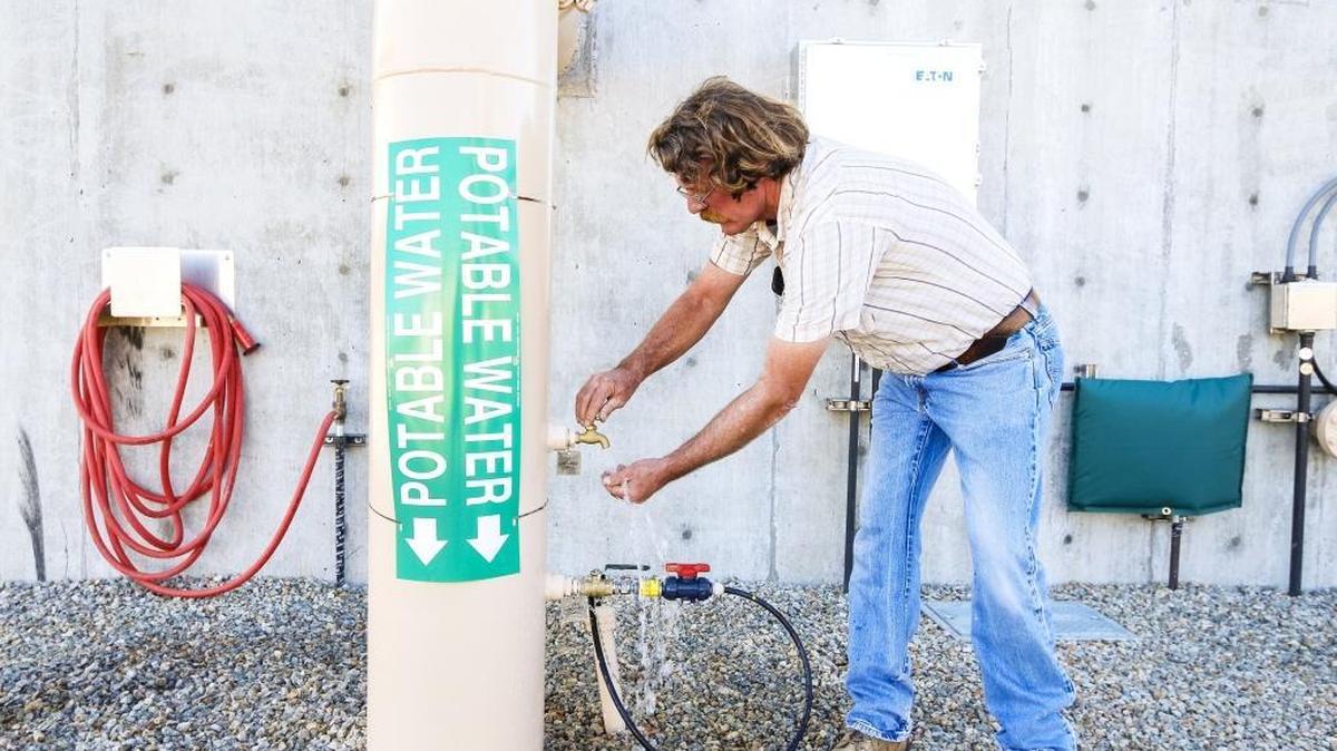 Water division supervisor/chief plant operator Mike Maaser, opens the tap to show off the finished product from Paso Robles' new water treatment plant.
